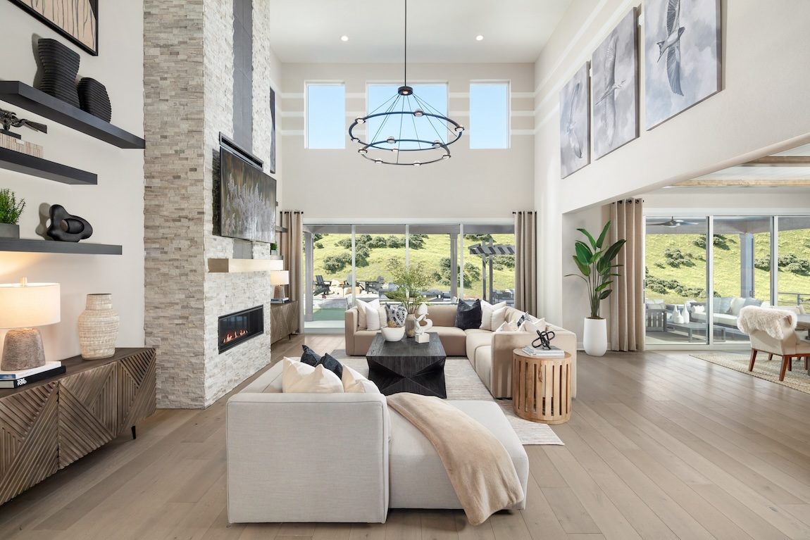 Spacious two-story great room highlighted by central fireplace accent wall