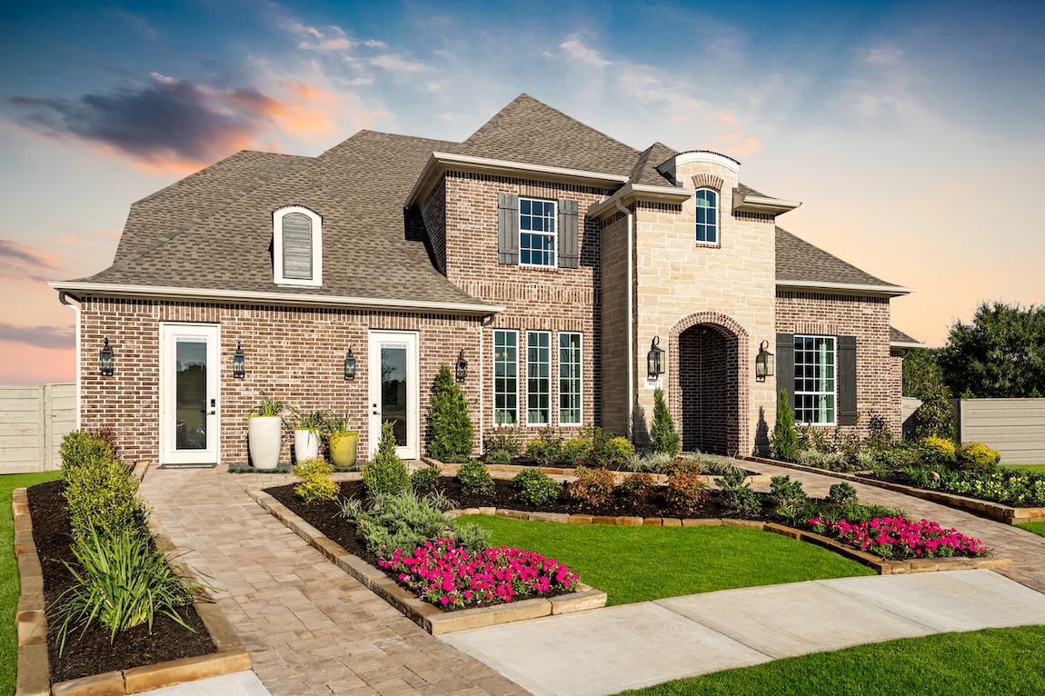 luxe home design featuring traditional exterior and elevated landscaping in Manvel, Texas