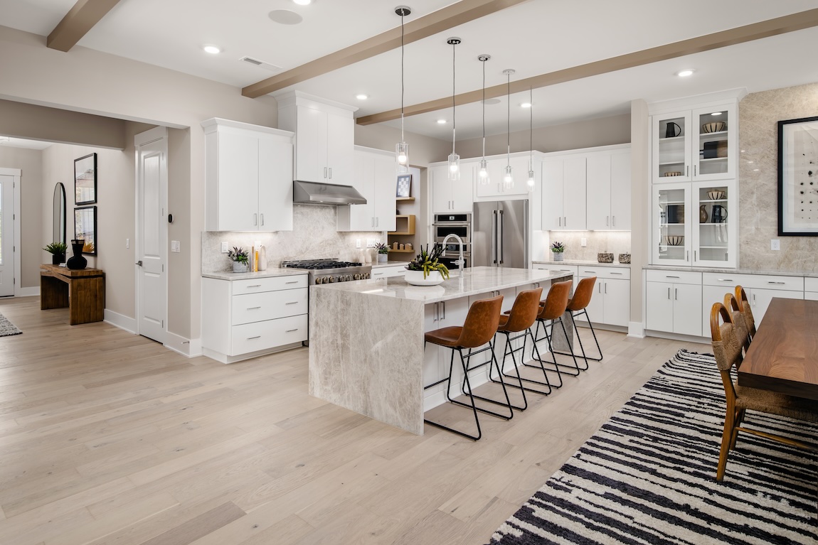 Light, airy modern kitchen design accented by ceiling wood beams