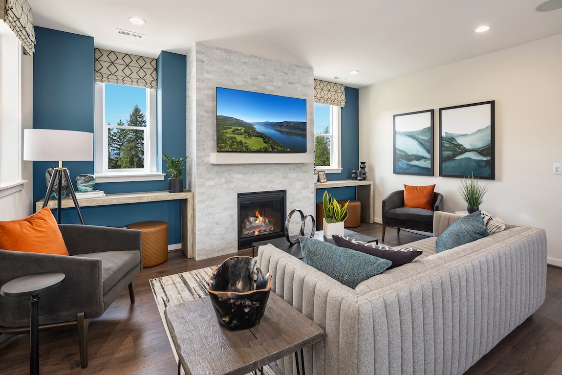 blue living room design featuring accent fireplace and wall