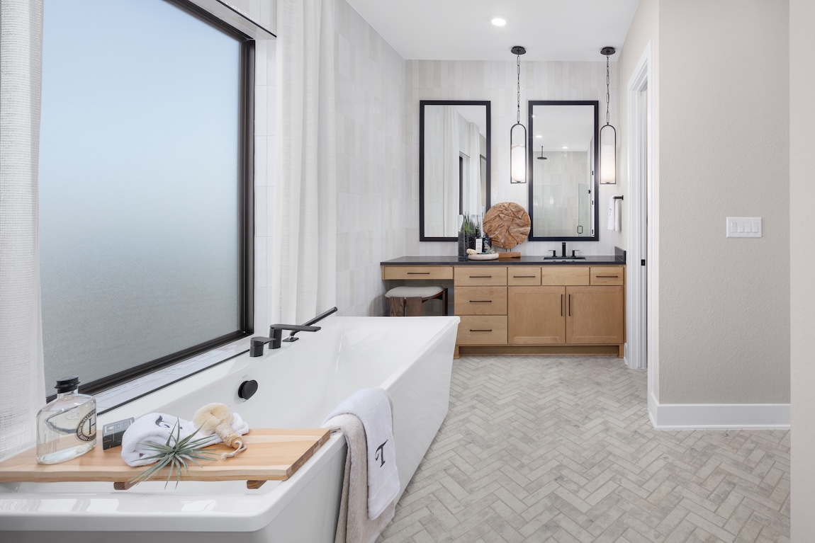 modern primary bathroom with herringbone tile flooring