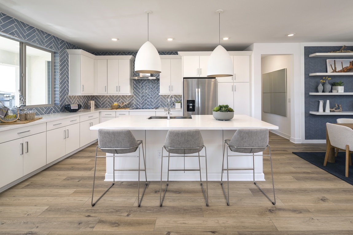 kitchen with white cabinetry and blue herringbone tile