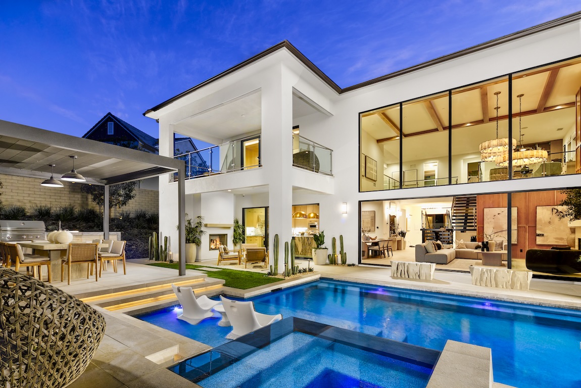 Sleek, dark pergola extending over an outdoor gathering area by the pool.