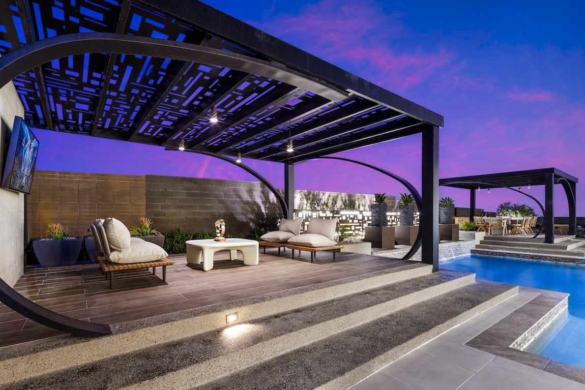 A luxurious pergola structure attached to a wall defining a private outdoor living space.