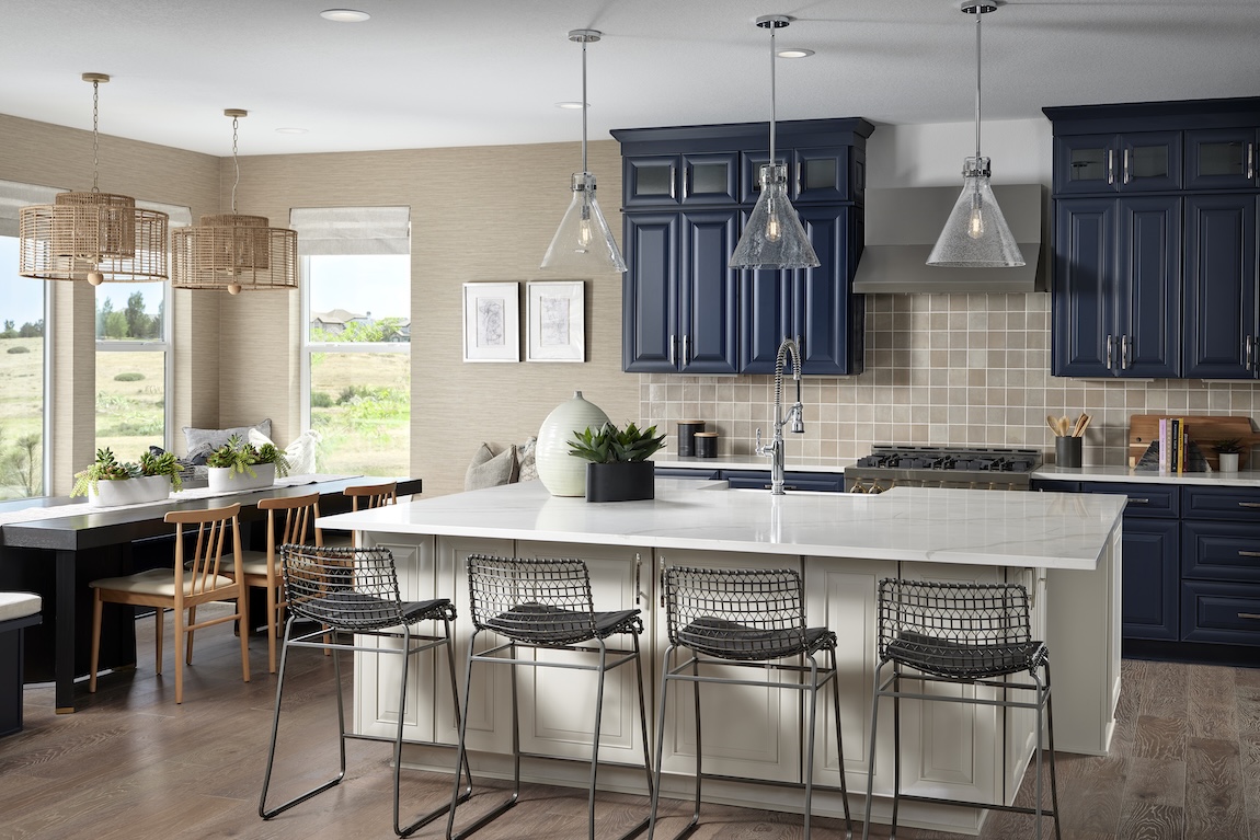 Luxury kitchen design with brown tile backsplash and industrial island chairs with quartz countertop.