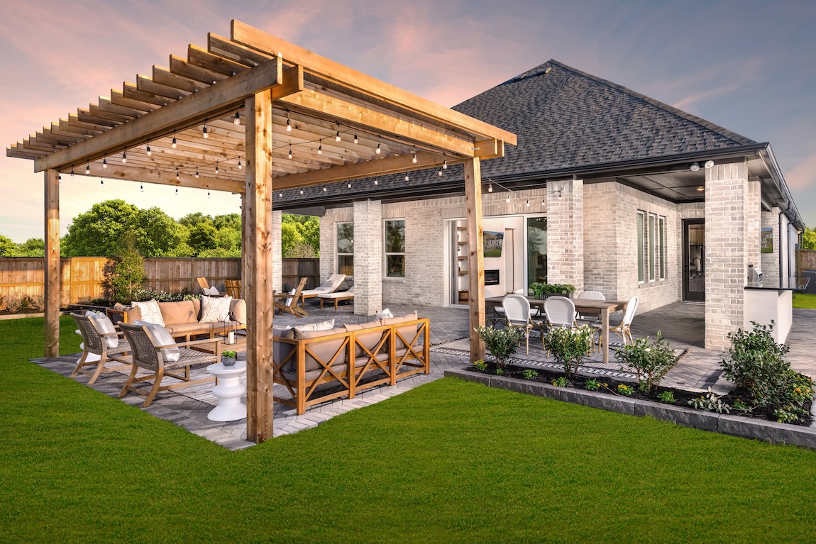 A wooden design with string lights elegantly sheltering outdoor furniture.