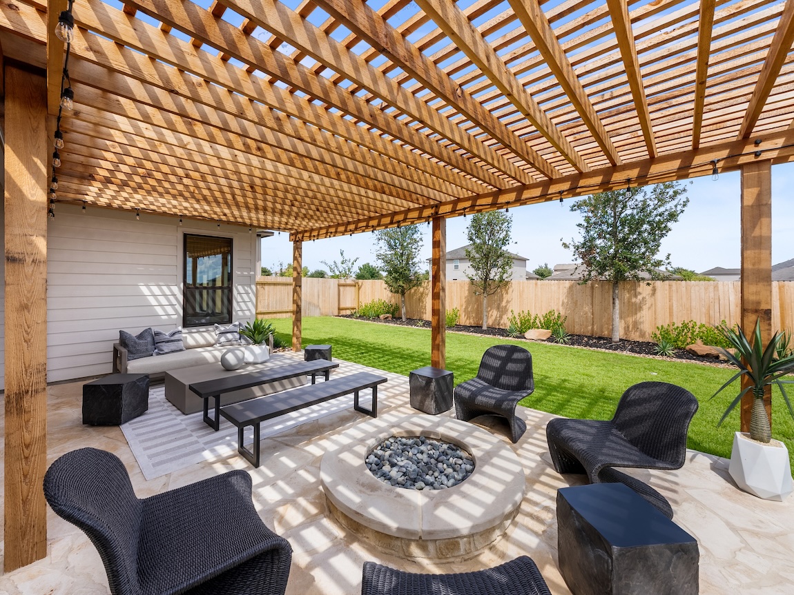 A grand wood pergola attached to the home.
