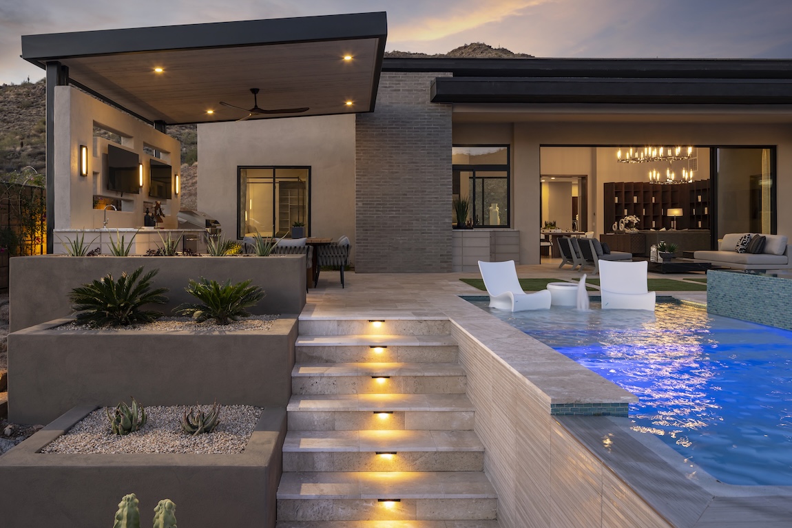 pool with lighting on the stairs and surrounding