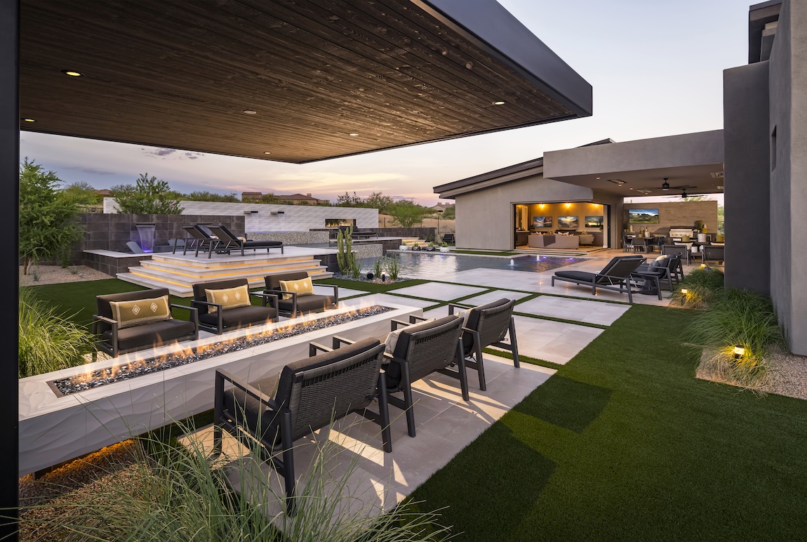 Luxury backyard design featuring modern fire pit, pool, and outdoor entertainment in Scottsdale, AZ