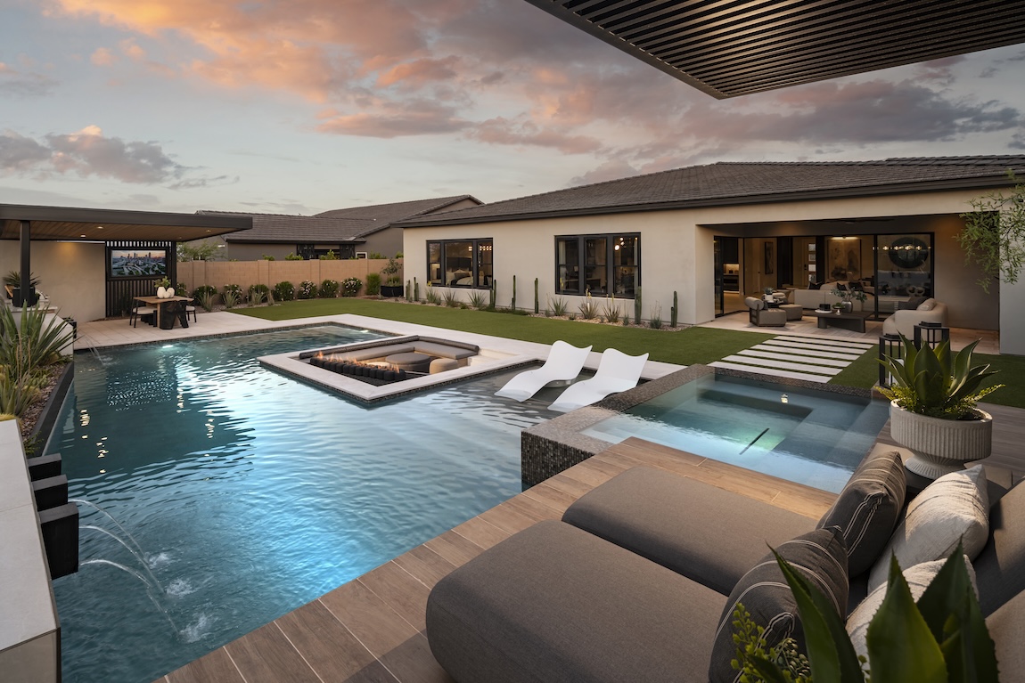 pool with resort landscaping and lounge seating areas