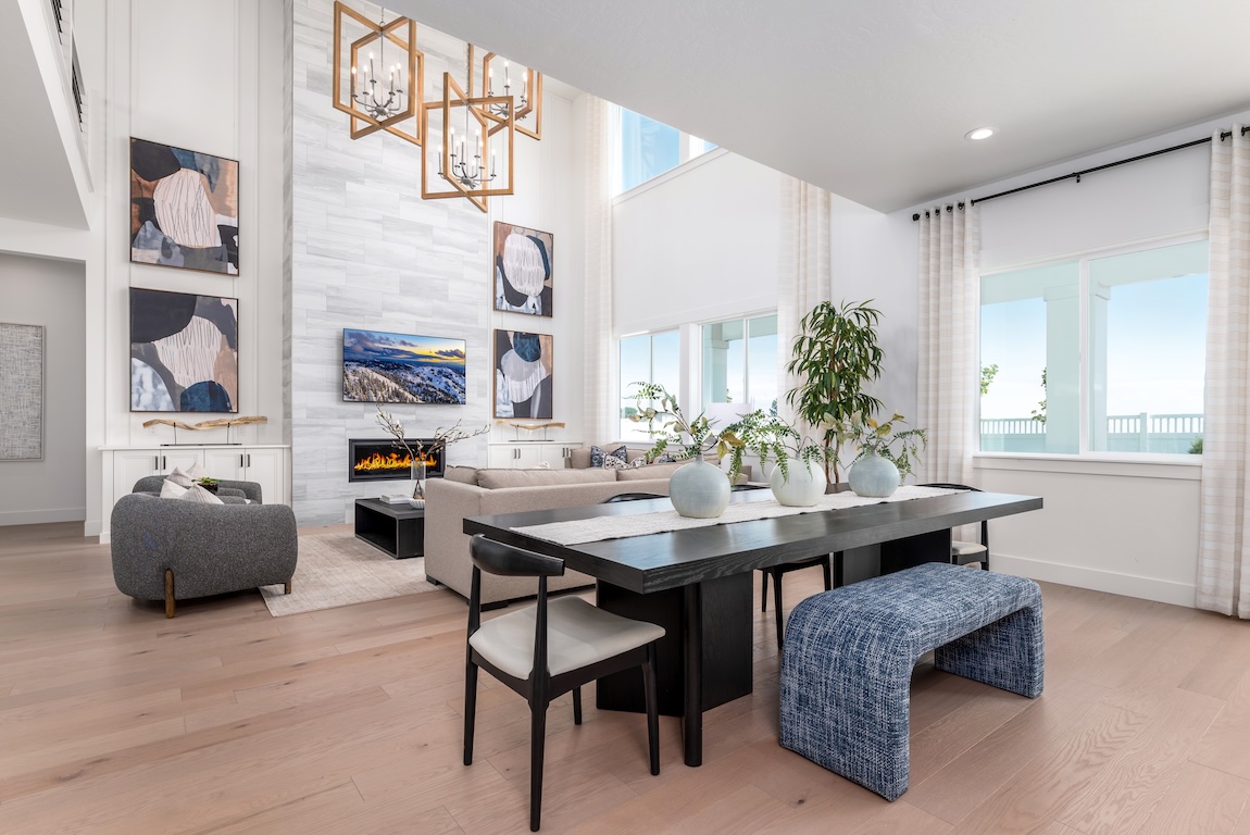 Luxe two-story great room featuring white color palette and stunning accent fireplace wall in Caldwell, ID
