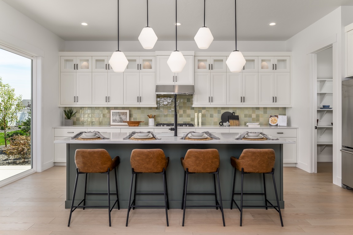 Light, airy modern kitchen highlighted by stylish green backsplash tile design in Caldwell, Idaho
