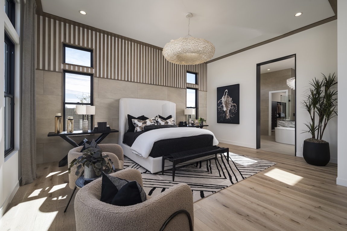 Bold, modern bedroom with striking black and white color palette from Sherwin-Williams 2025 color capsule, textural wallpaper, and designer pendant lighting, balanced by wood flooring and contemporary decor."