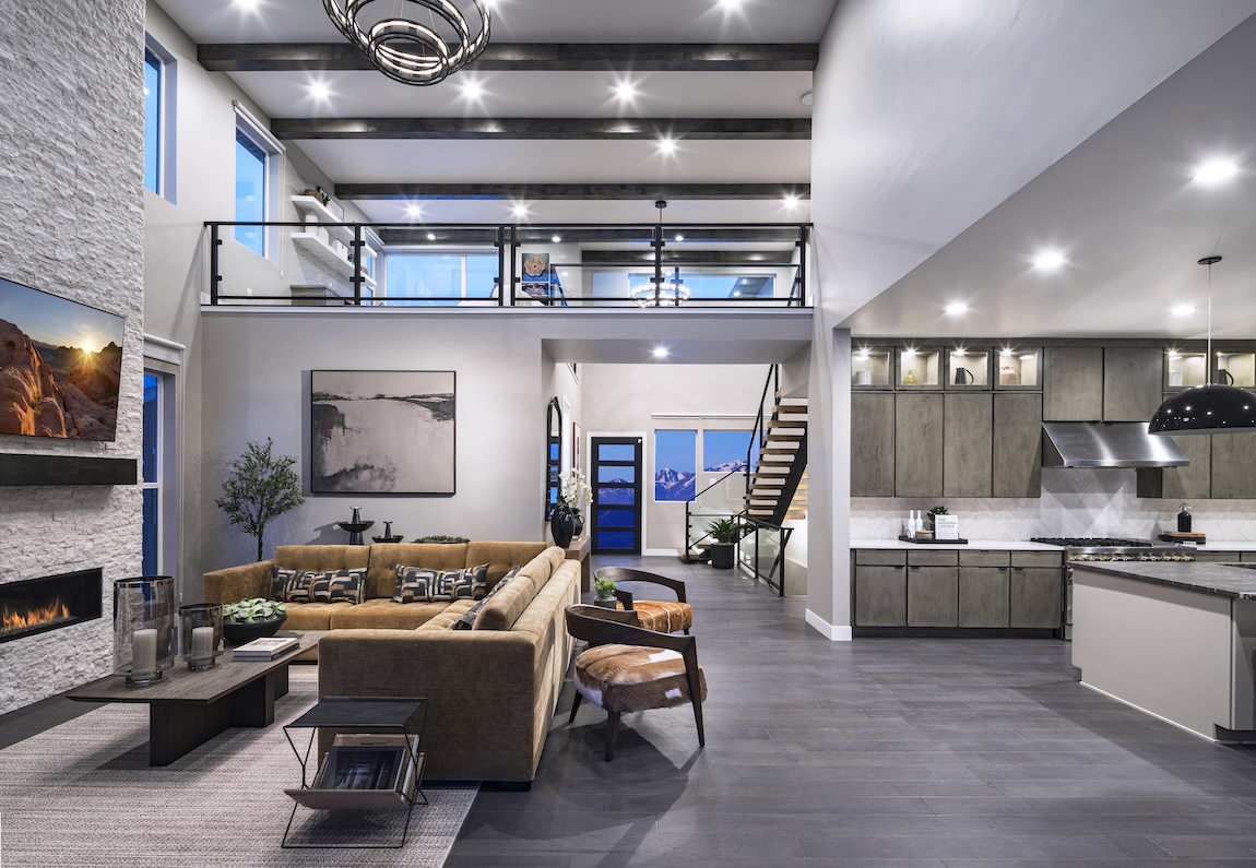 modern open-concept living space with high ceilings and mountain views.