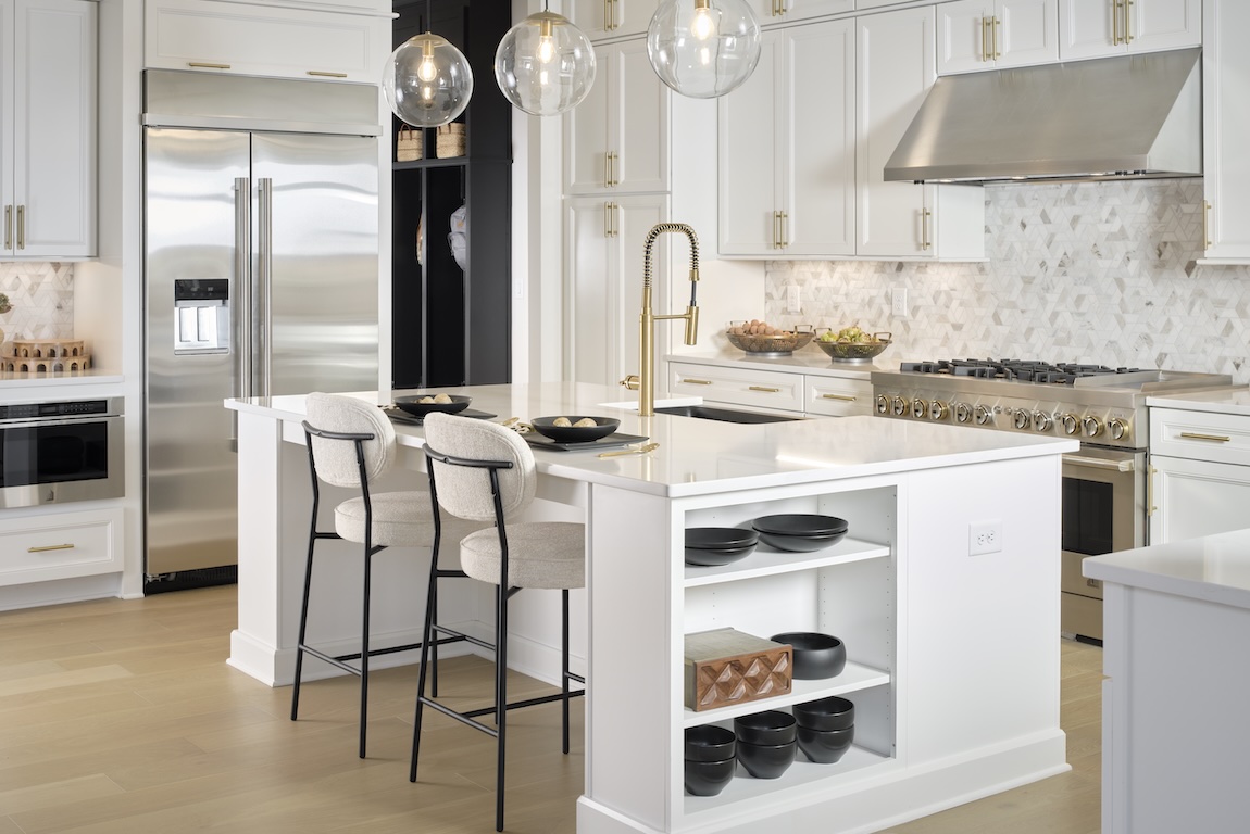 modern kitchen with gold fixtures and marble countertops