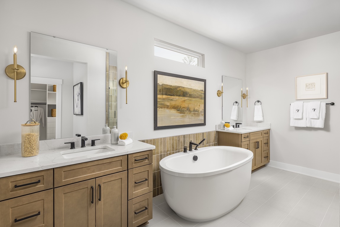 freestanding bathtub between dual vanities