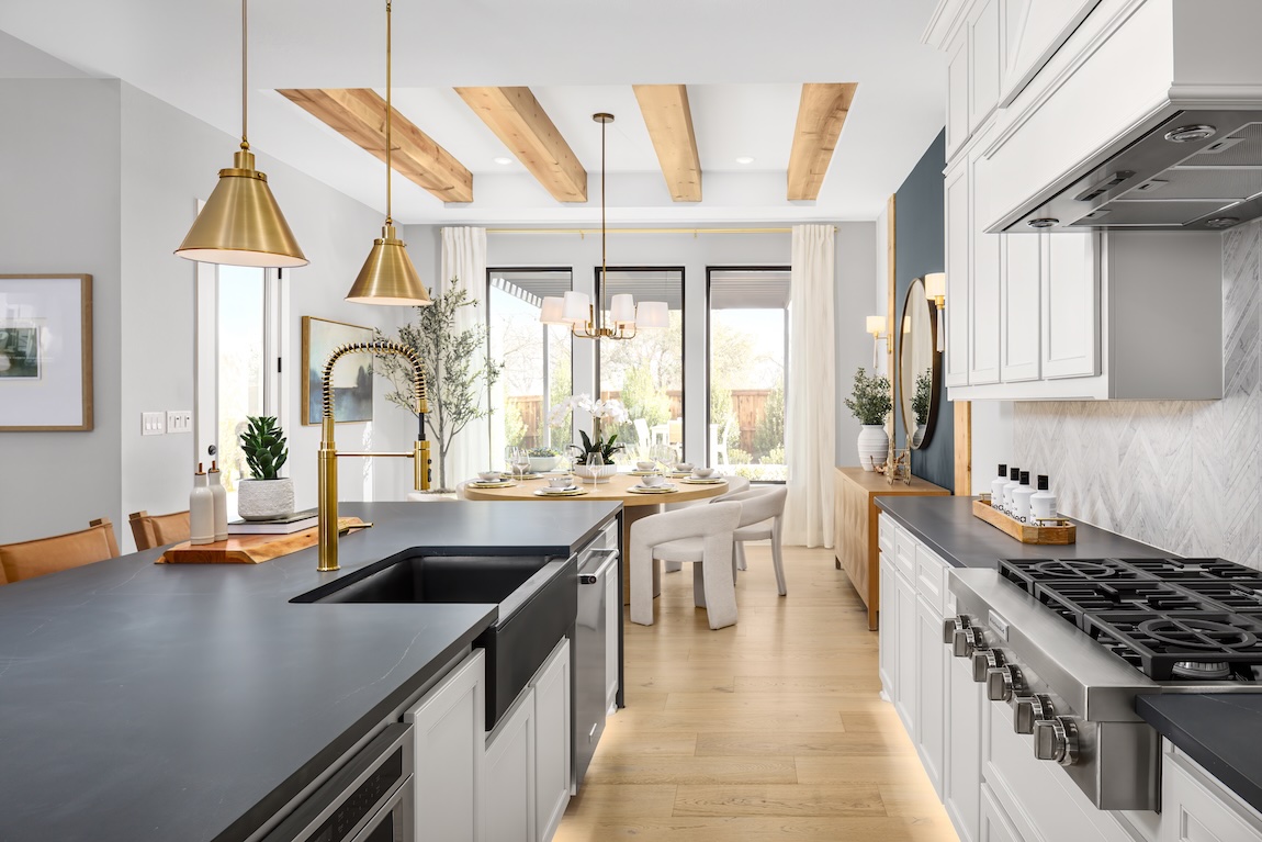 modern farmhouse kitchen with wood beam ceiling and gold fixtures
