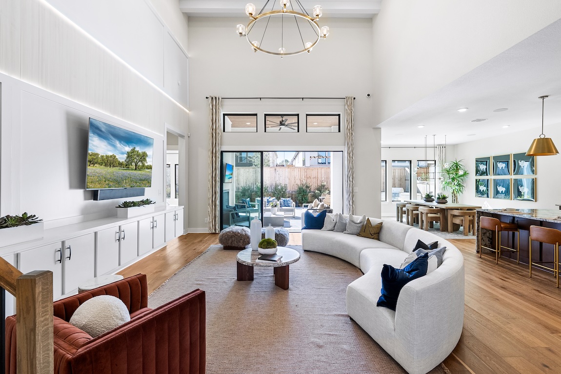 Luxe light, airy great room, dining space, and kitchen with outdoor transition