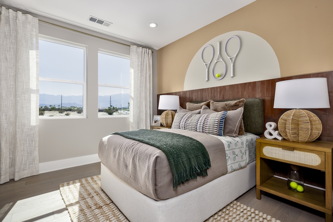 Tennis-themed bedroom with mounted rackets and tennis ball