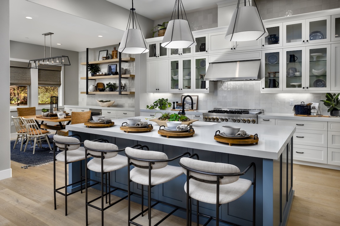 modern kitchen with blue island and statement lighting