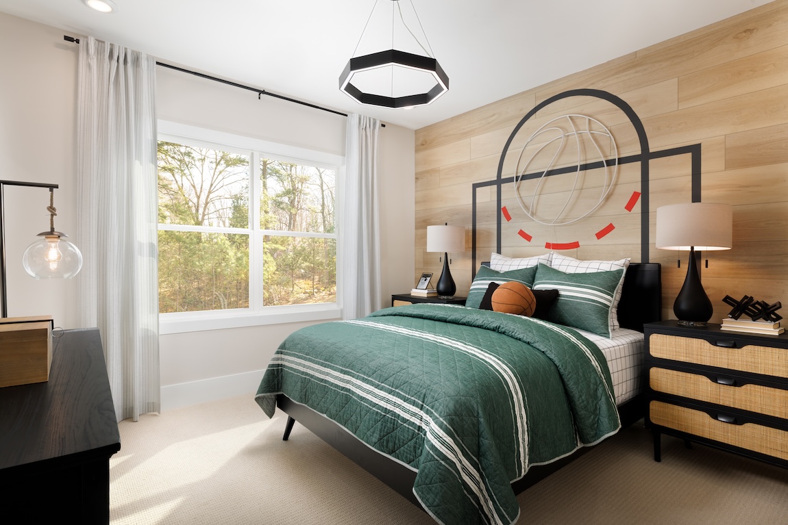 Basketball-themed bedroom with an accent wall and basketball pillow.