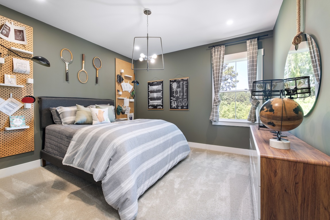 kids bedroom featuring tennis racket wall decor and dual peg shelving