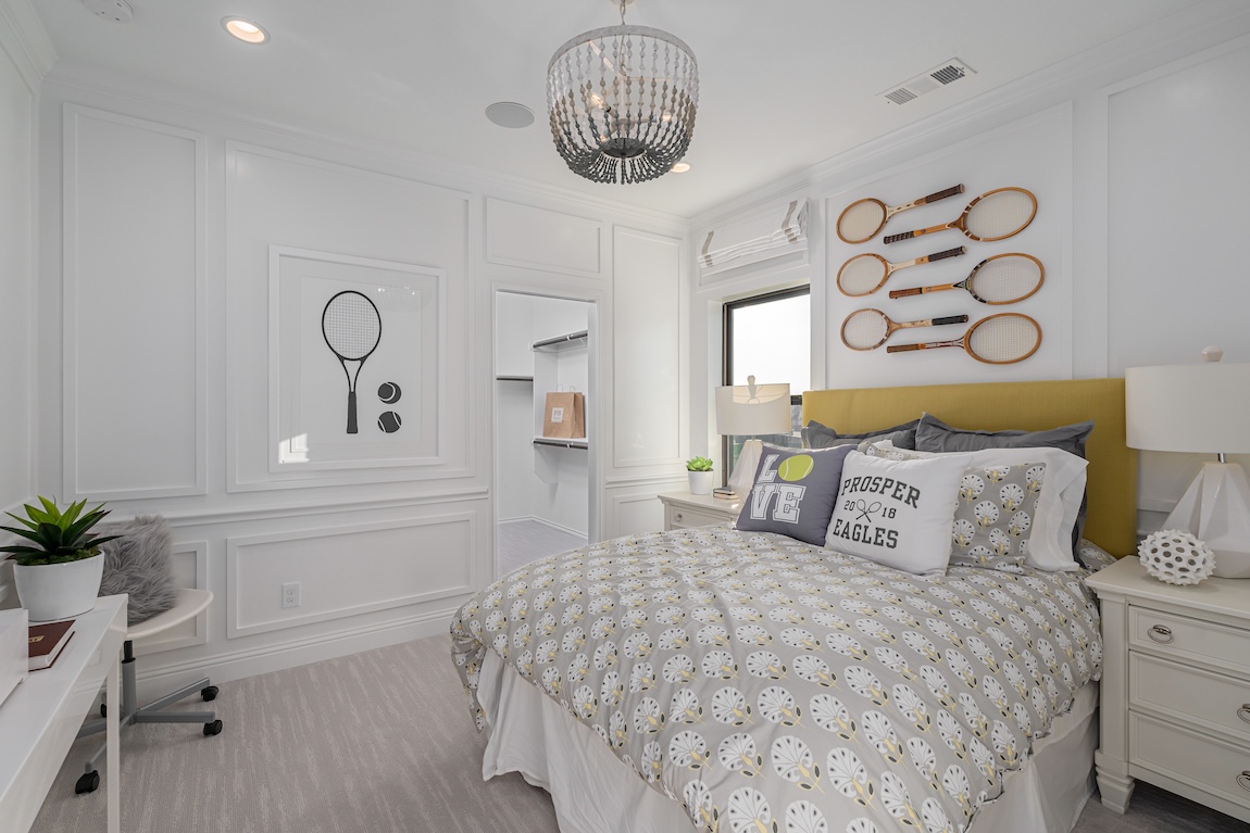 Tennis themed bedroom with rackets on the wall.