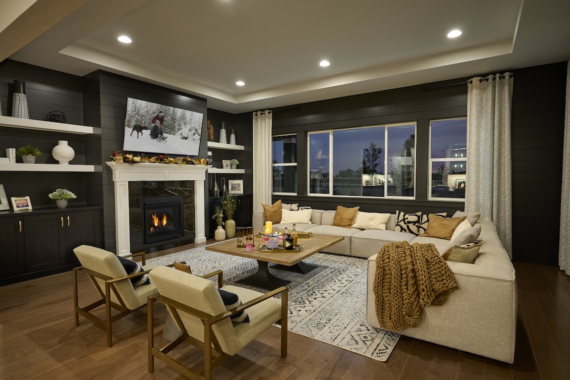 warm, inviting great room design featuring charming fireplace and fall decor