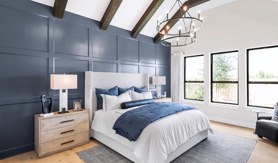 Blue contemporary bedroom design with grid accent wall, wood ceiling beams, and rustic chandelier
