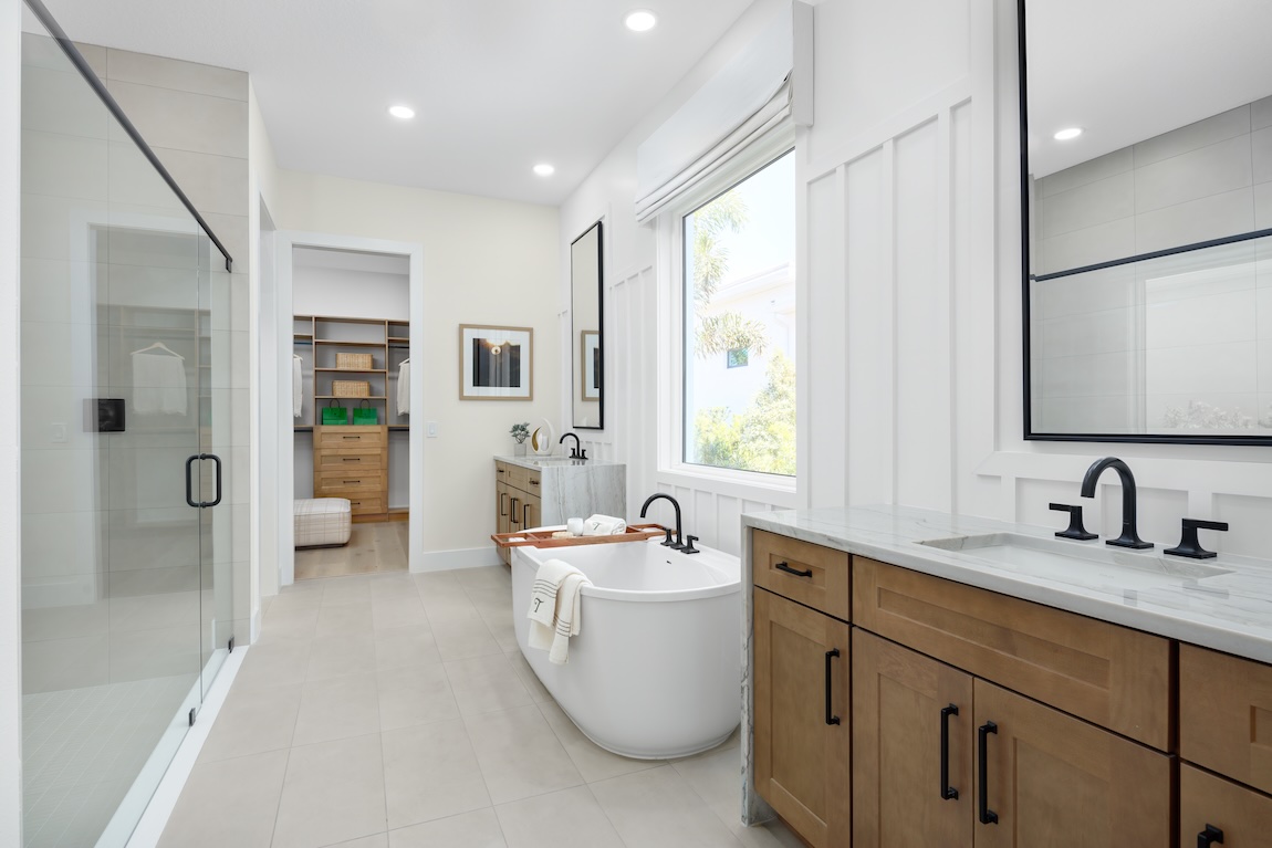 primary bathroom with freestanding tub and dual sink vanities