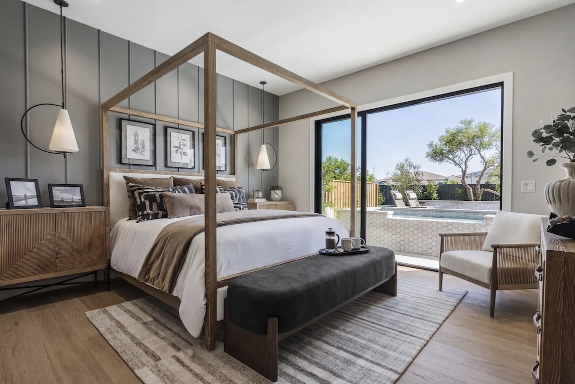 primary bedroom with glass doors leading to the outdoor pool