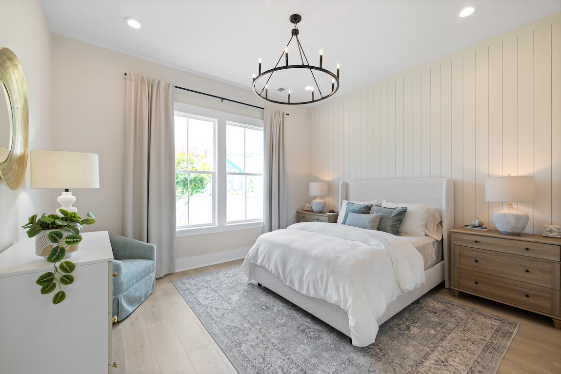 guest room with light, airy color palette and ample natural lighting