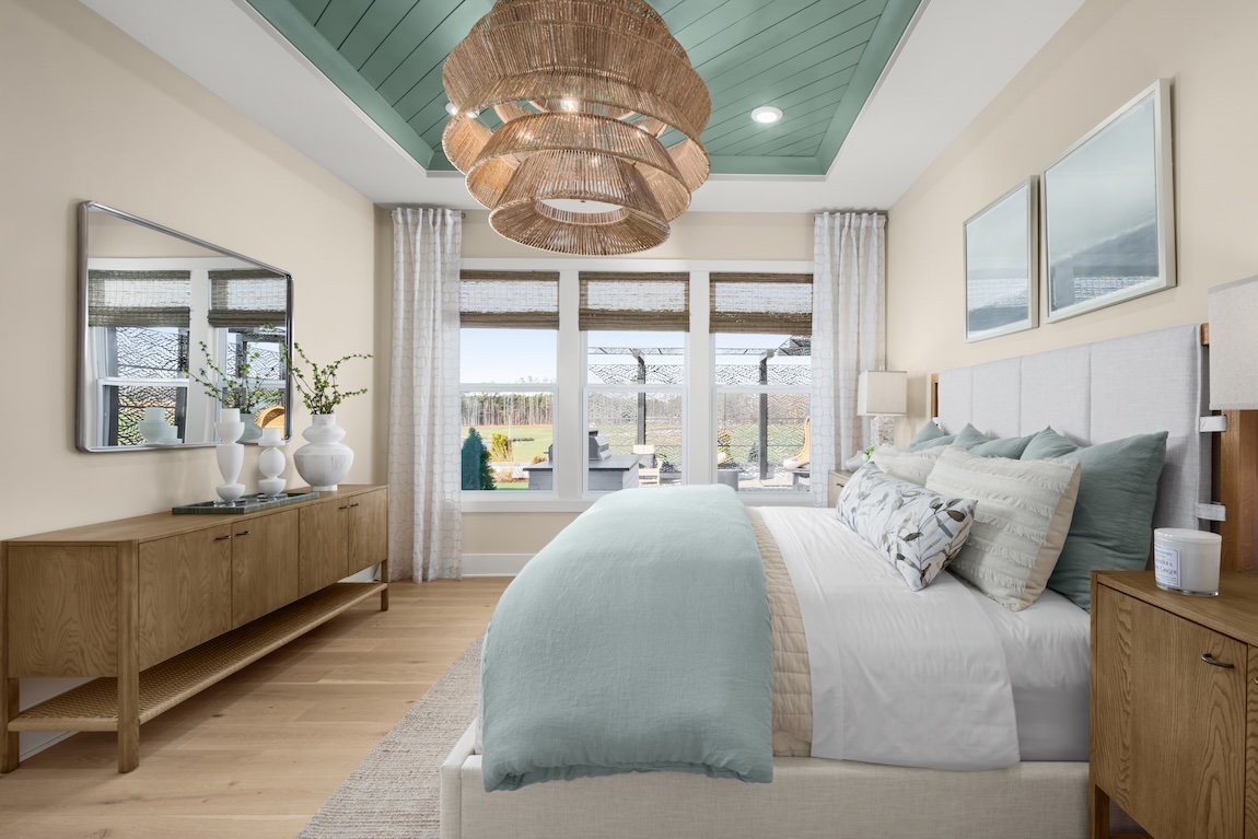primary bedroom with views of the outdoor living space and a neutral color palette
