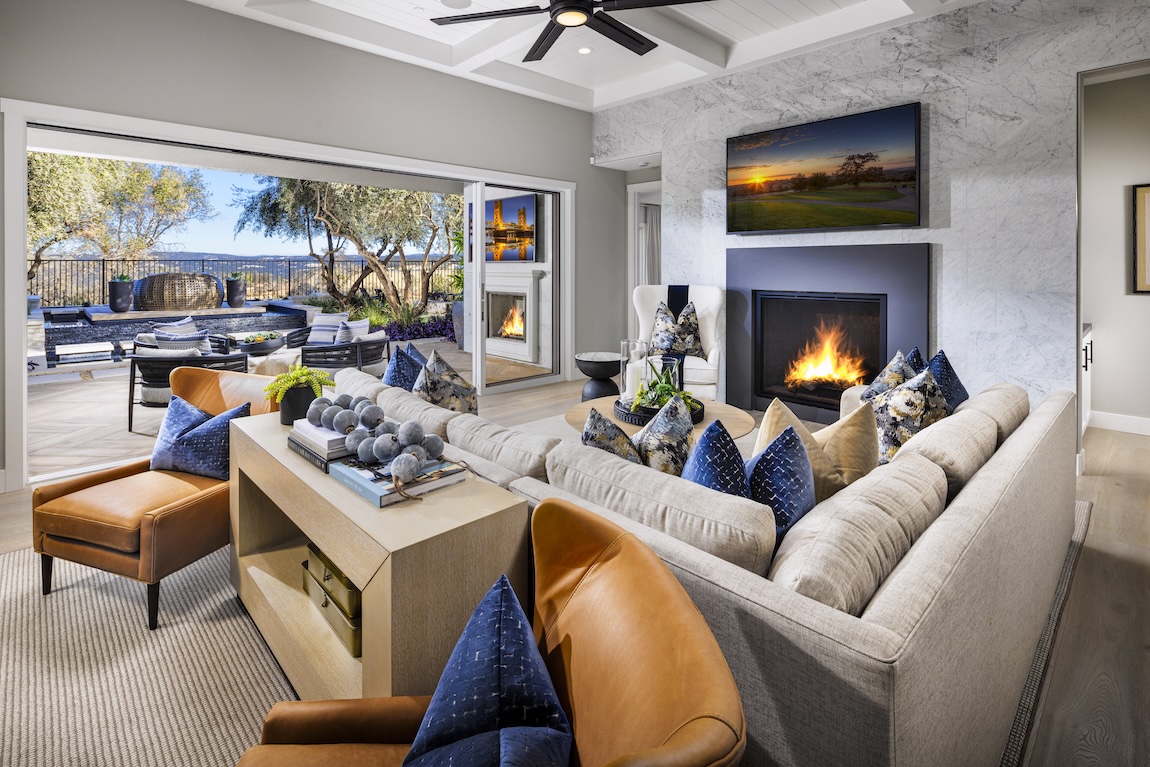 modern living room with an orange and blue color scheme and access to the outdoor living space.