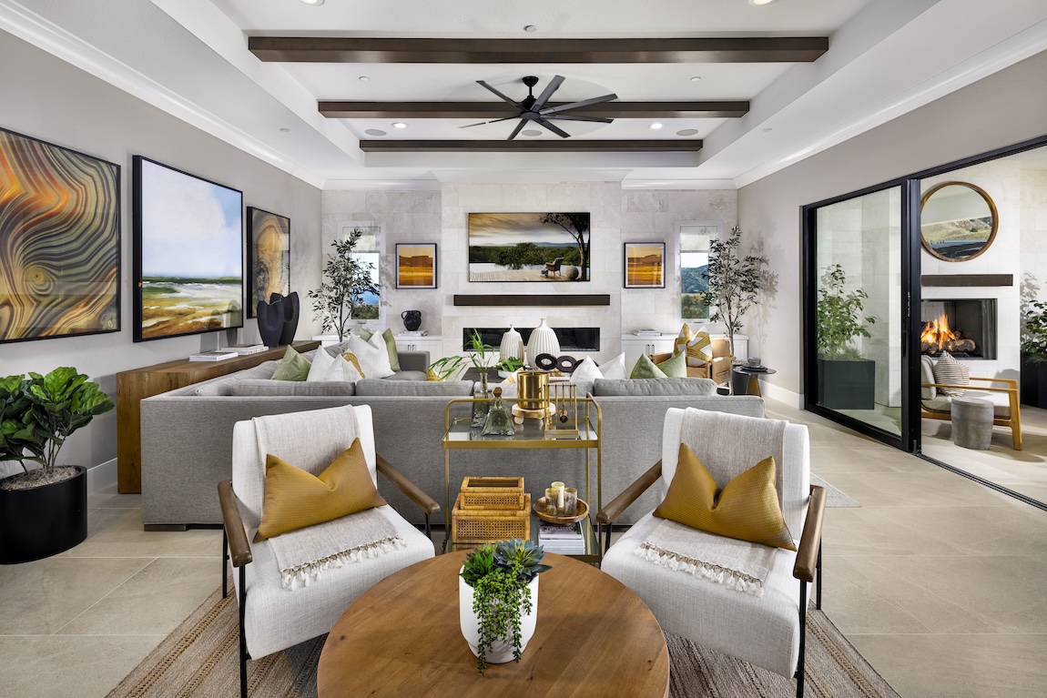 Living room with large sectional couch and sliding glass doors.