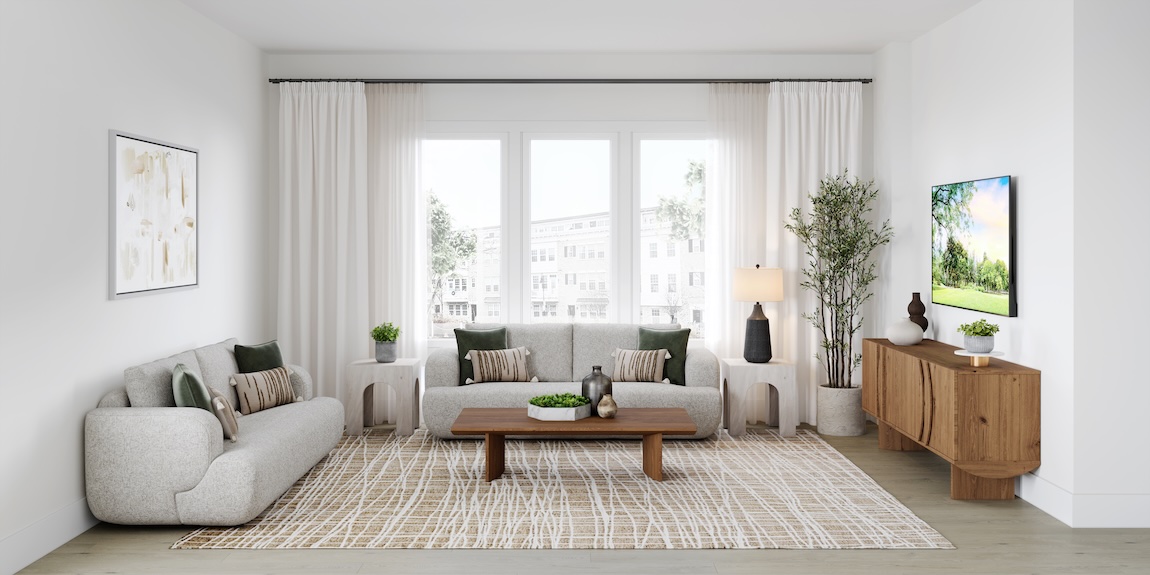 Modern organic great room with curved neutral sofas, sheer drapery, wood console table, and layered natural textures.