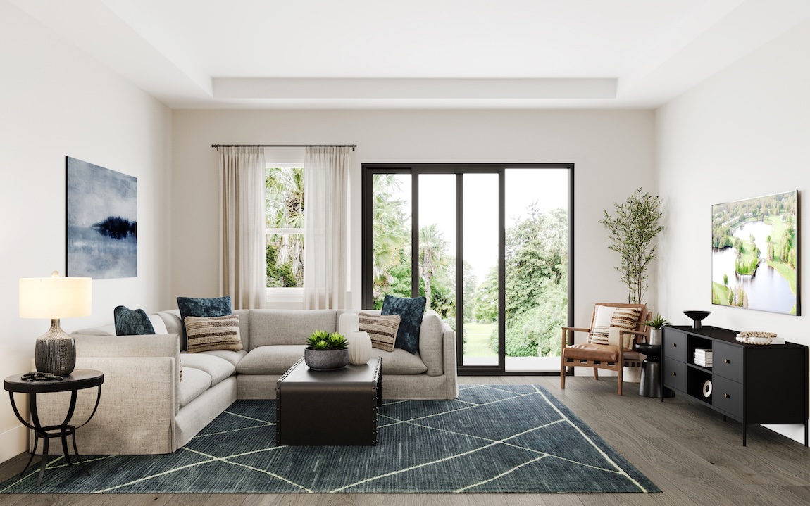 Contemporary great room with sectional sofa, geometric area rug, sliding glass doors, and modern console table overlooking lush greenery.