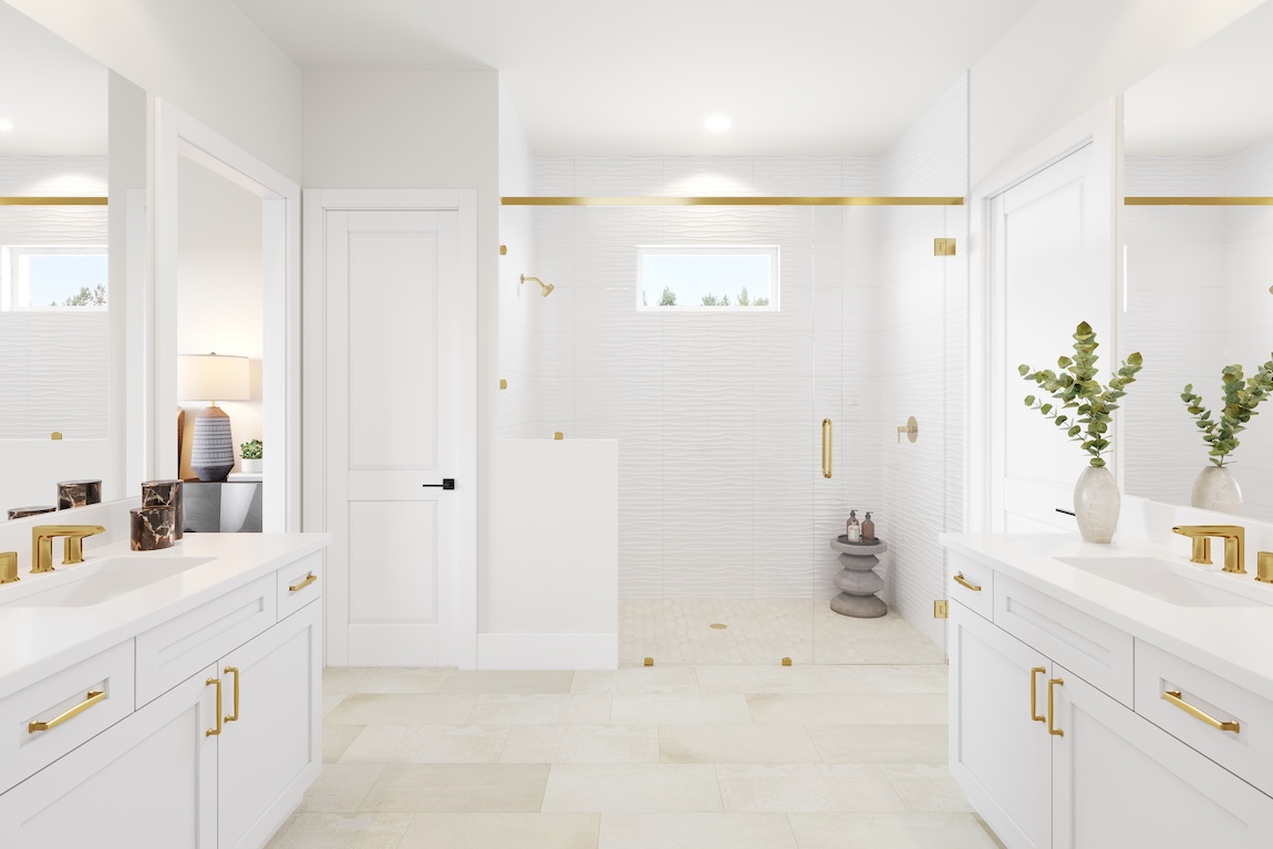 Warm contemporary primary bathroom with dual white vanities, brass fixtures, glass walk-in shower, and soft neutral tile finishes.