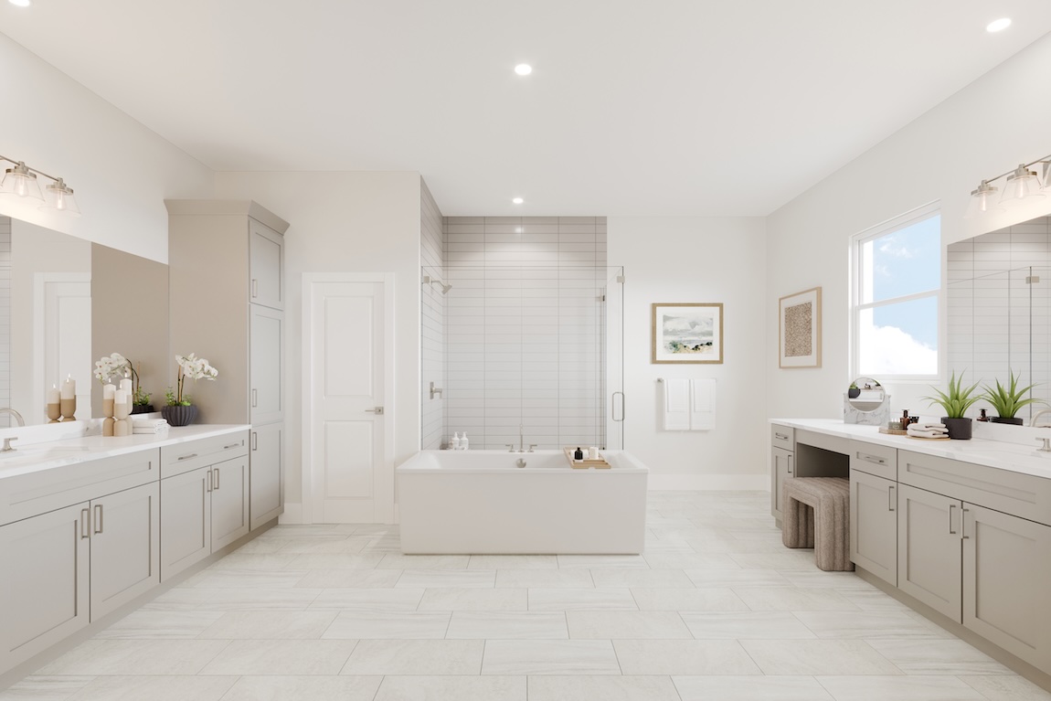 Spacious primary bathroom with dual vanities, freestanding soaking tub, glass-enclosed shower, and light tile flooring.