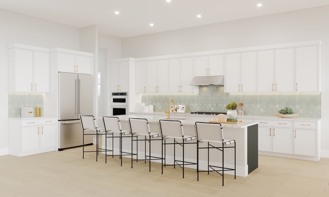 Bright white kitchen with expansive cabinetry, oversized island with seating, gold hardware, and soft green tile backsplash.