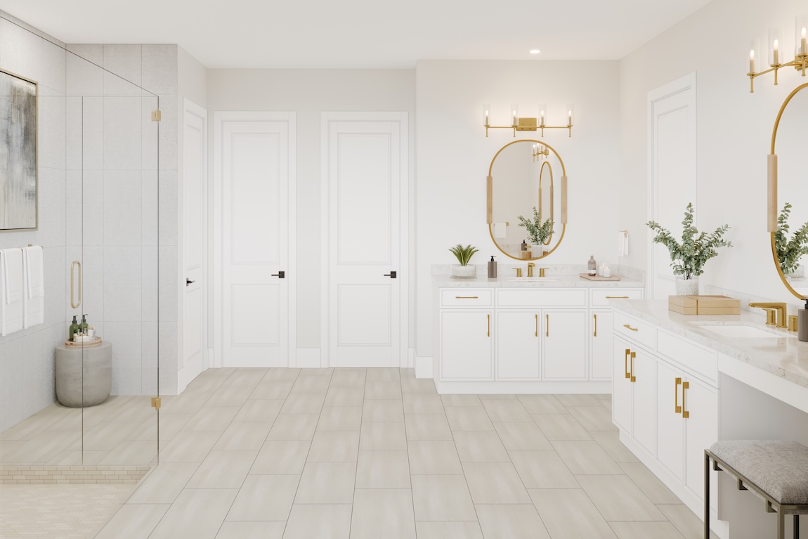 Elegant primary bathroom with dual white vanities, gold fixtures, glass-enclosed shower, and light tile flooring.