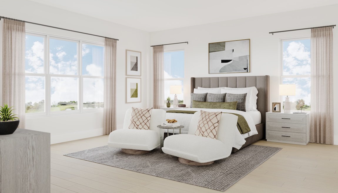 Spacious primary bedroom with upholstered bed, sitting area with lounge chairs, large windows, and soft neutral finishes.