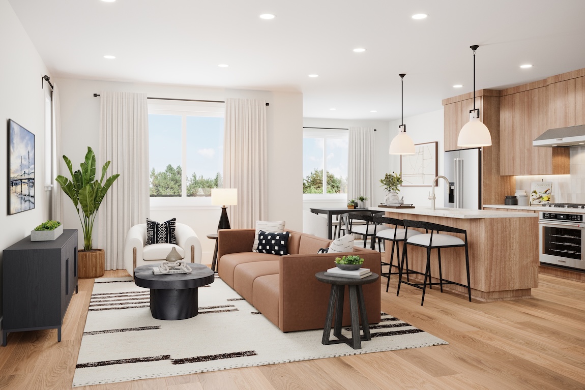 Open-concept great room and kitchen with leather sofa, wood cabinetry, globe pendant lighting, and warm neutral palette.