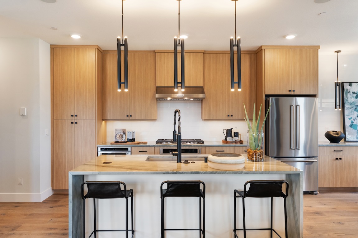 modern kitchen with wooden cabinetry and a waterfall island.