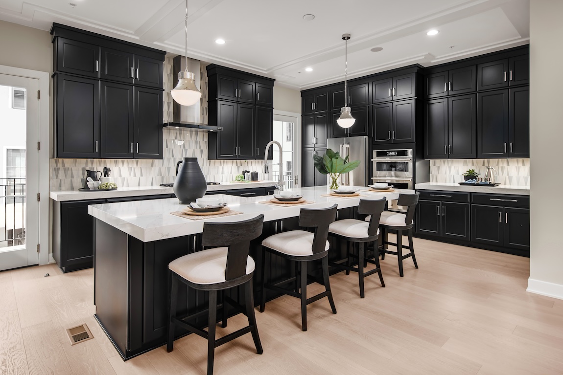 kitchen with black cabinetry and gray tile