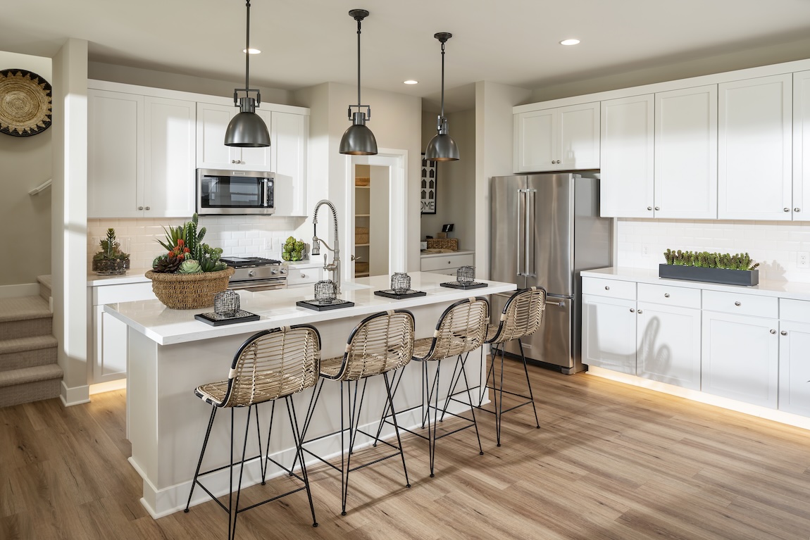 modern kitchen with island and white cabinetry.