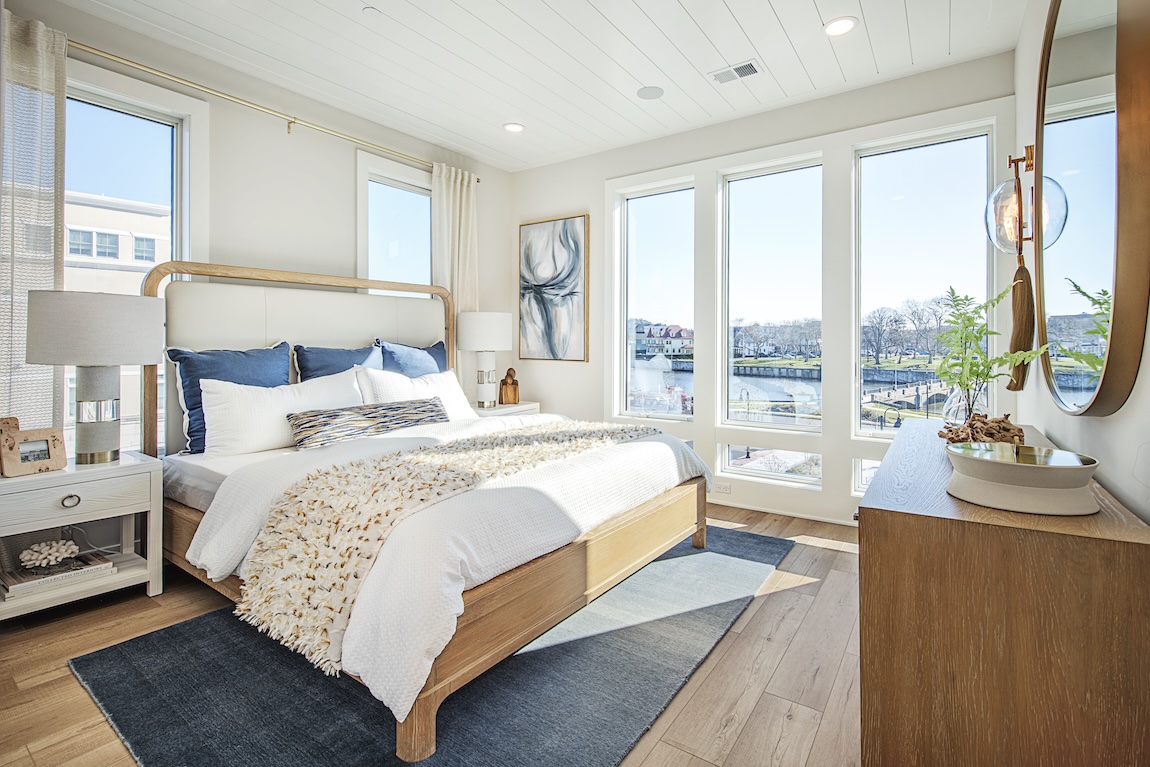 Primary bedroom with views of the water and natural light.