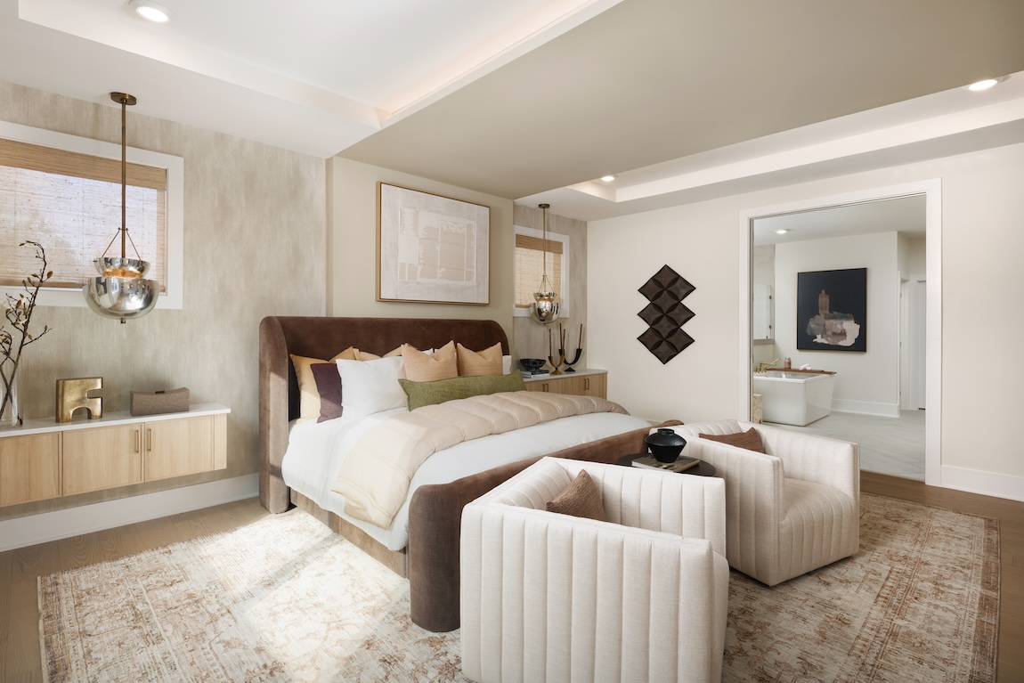 primary bedroom with doorway to the primary bathroom