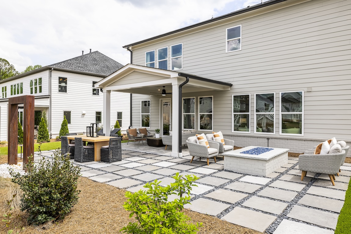 Backyard space with covered area as well as firepit and seating.