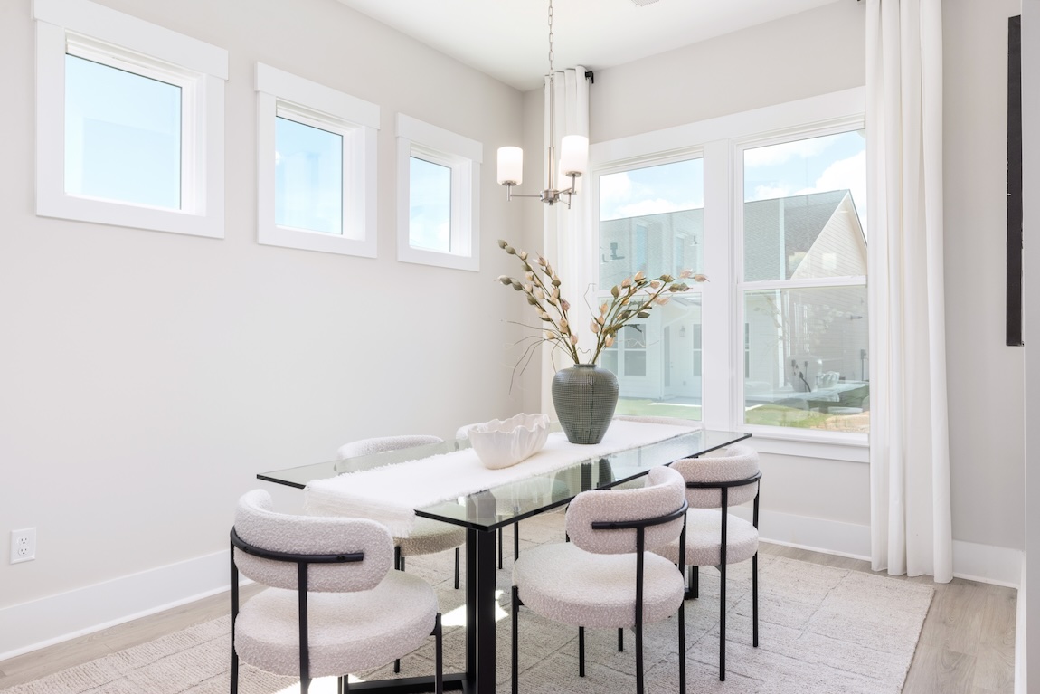 luxury dining room with glass table and white seating